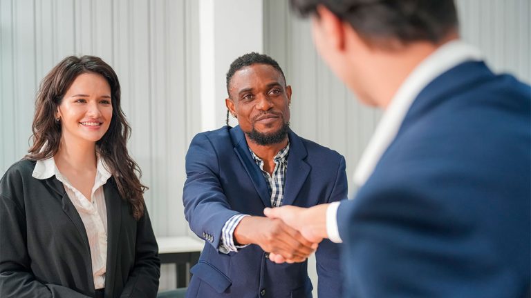 Homens em aperto de mão em escritório